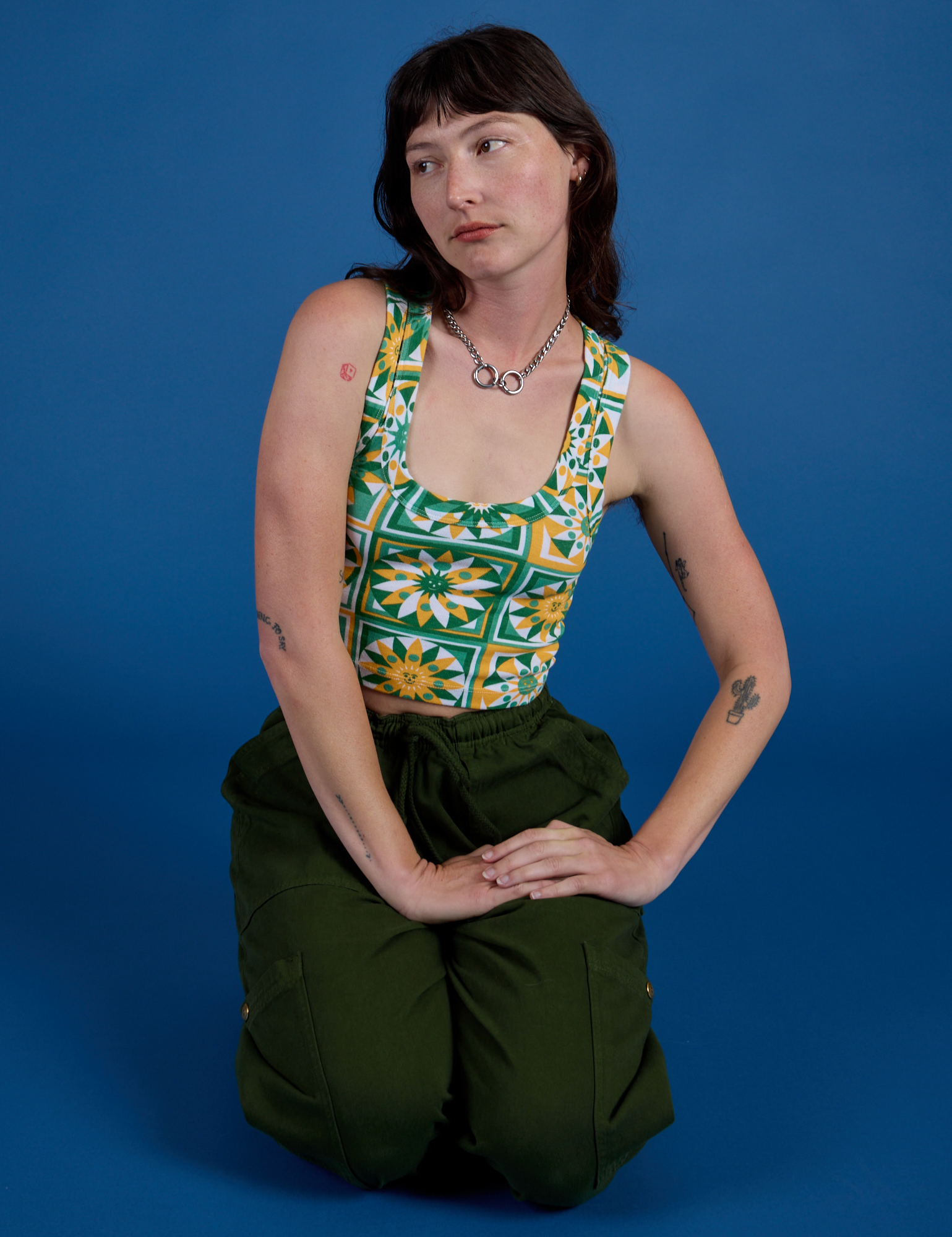 Cropped Tank Top in Spring Quilt Print and evergreen Drop Pocket Cargo Pants on Alex