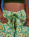 Close up of. Drop Pocket Cargo Pants in Spring Quilt Print with Kandia pulling on. the drawstring