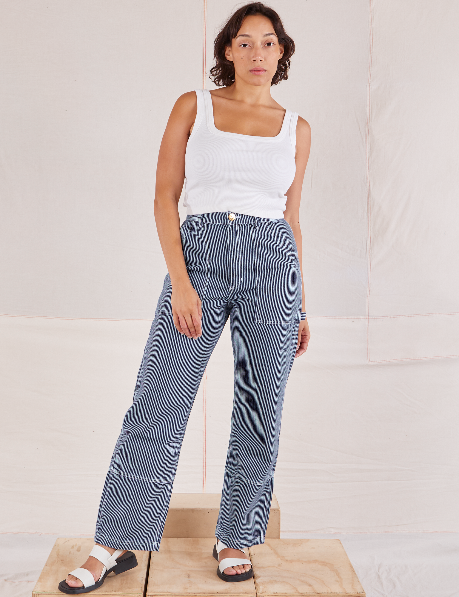 Tiara is 5'4" and wearing S  Carpenter Jeans in Indigo Railroad paired with vintage tee off-white Square Neck Tank
