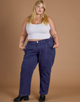 Juliet is 5’7” and wearing 2XL Railroad Denim Work Pants in Faded Grape Overdye paired with vintage tee white Cropped Tank