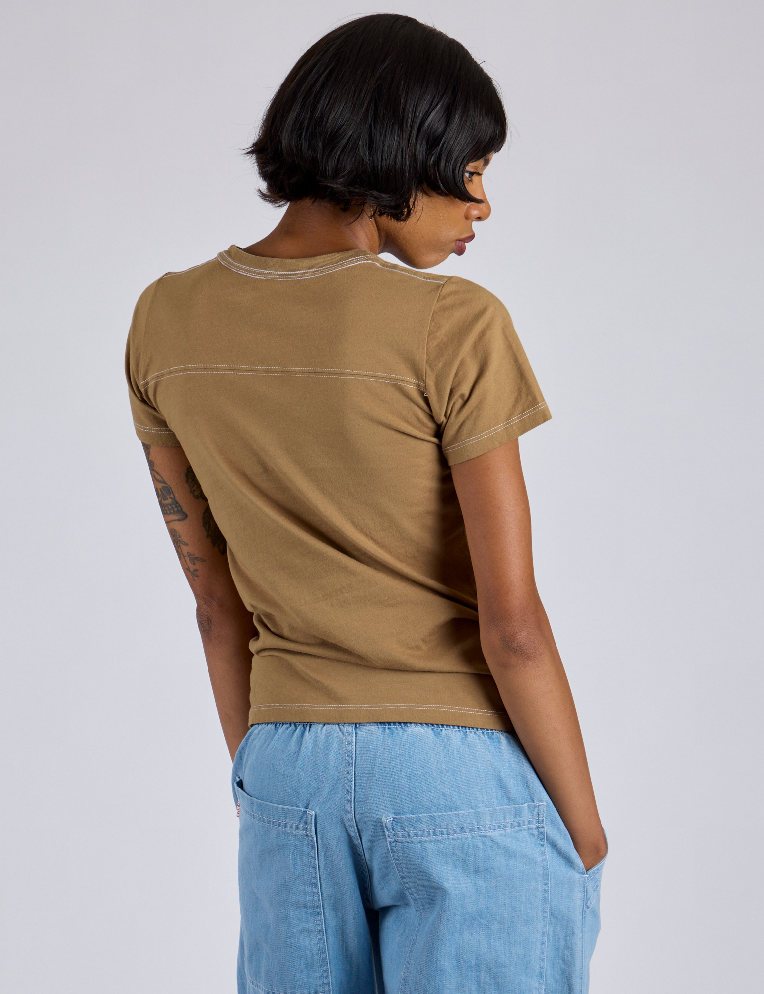 Back view of Jr. Varsity Tee in Desert Brown on Kira
