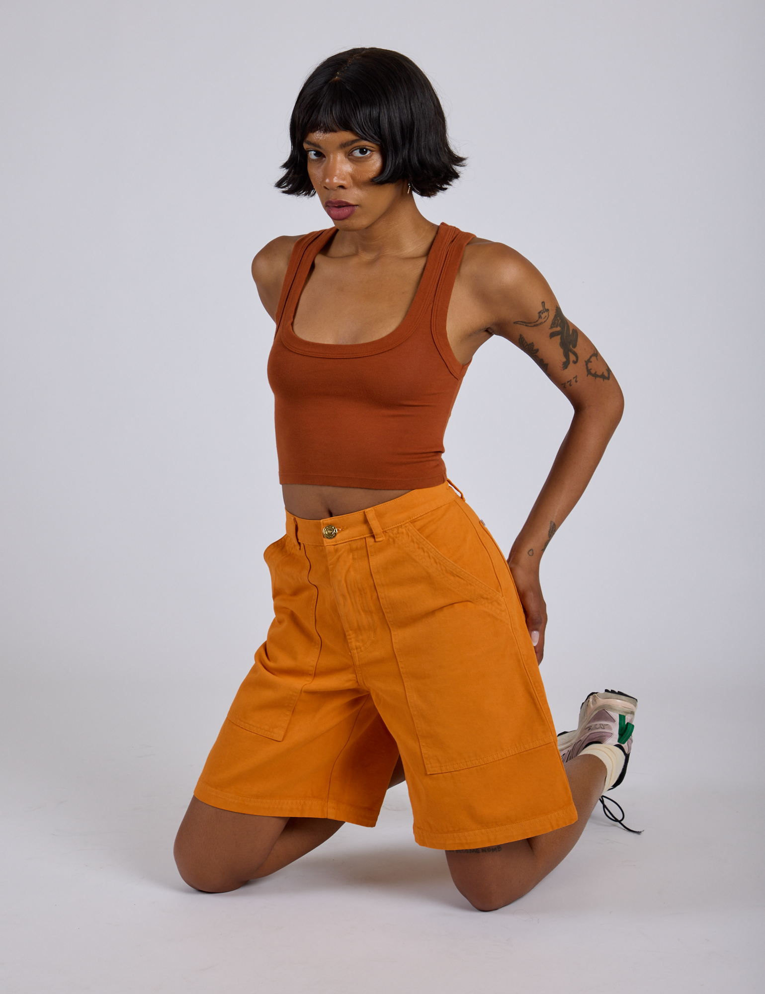 Longline Work Shorts in Creamsicle Orange and burnt terracotta Cropped Tank worn by Kira