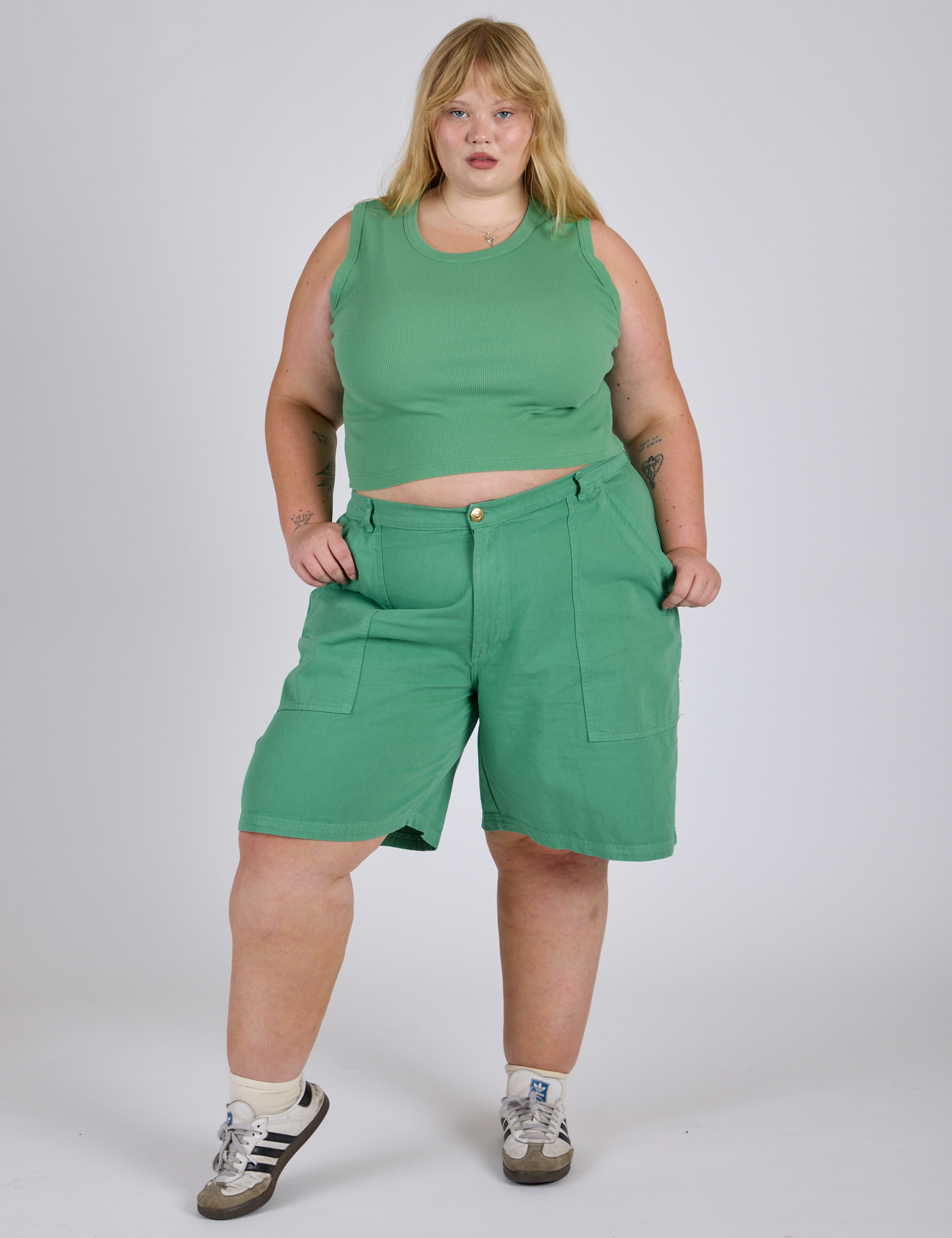 Juliet is 5’7” and wearing 2XL Longline Work Shorts in Seafoam Green with matching Muscle Tee