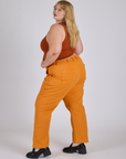 Work Pants in Creamsicle Orange side view on Juliet