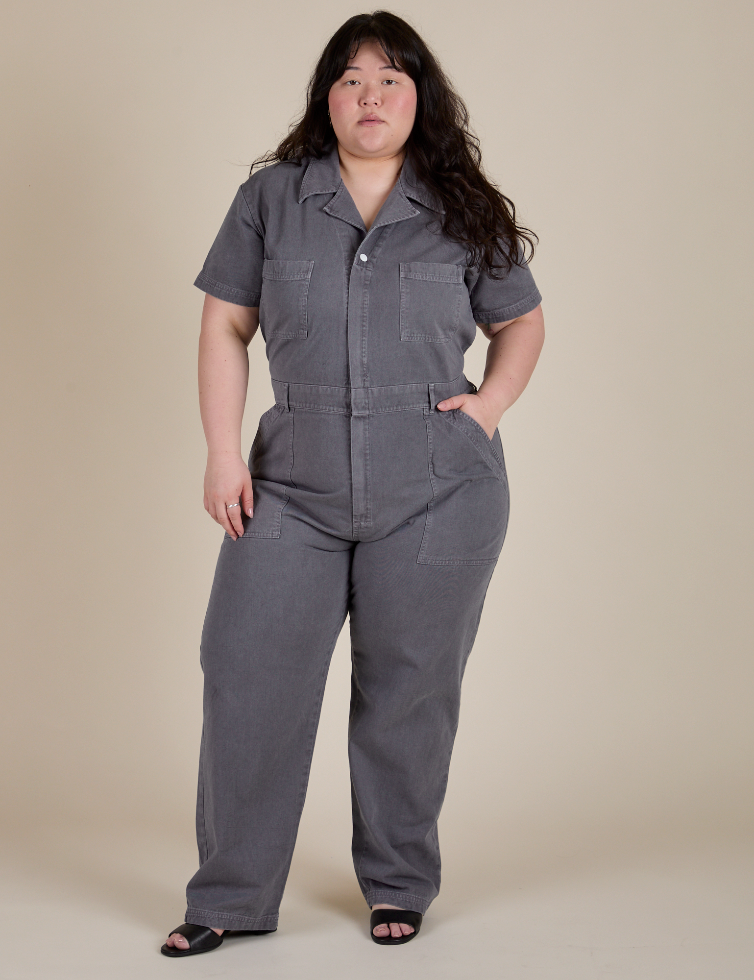 Ashley is 5'7" and wearing 1XL Short Sleeve Jumpsuit in Washed Grey
