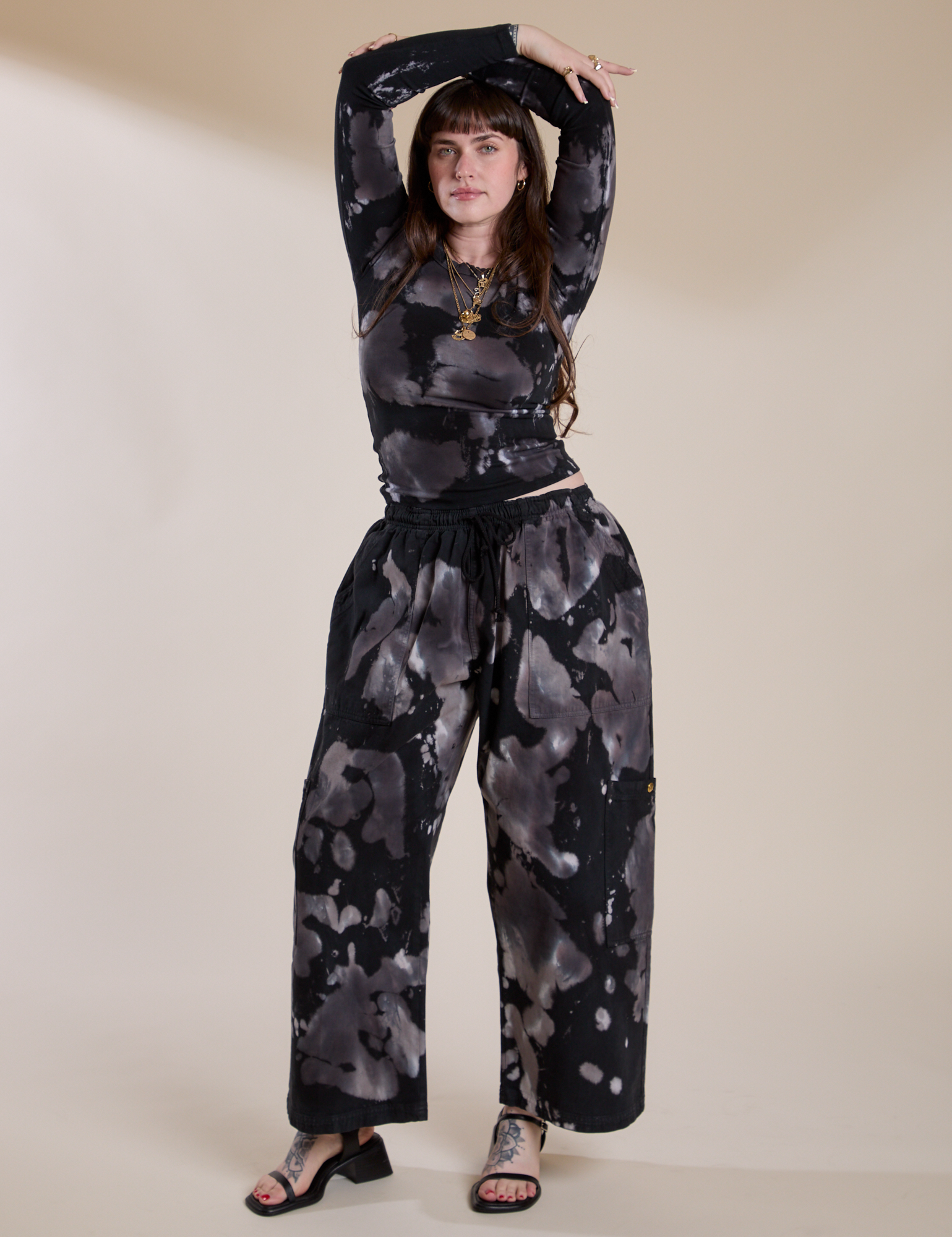 Sydney is wearing Magic Waters Drop Pocket Pants in Ink Blot and matching long sleeve baby tee