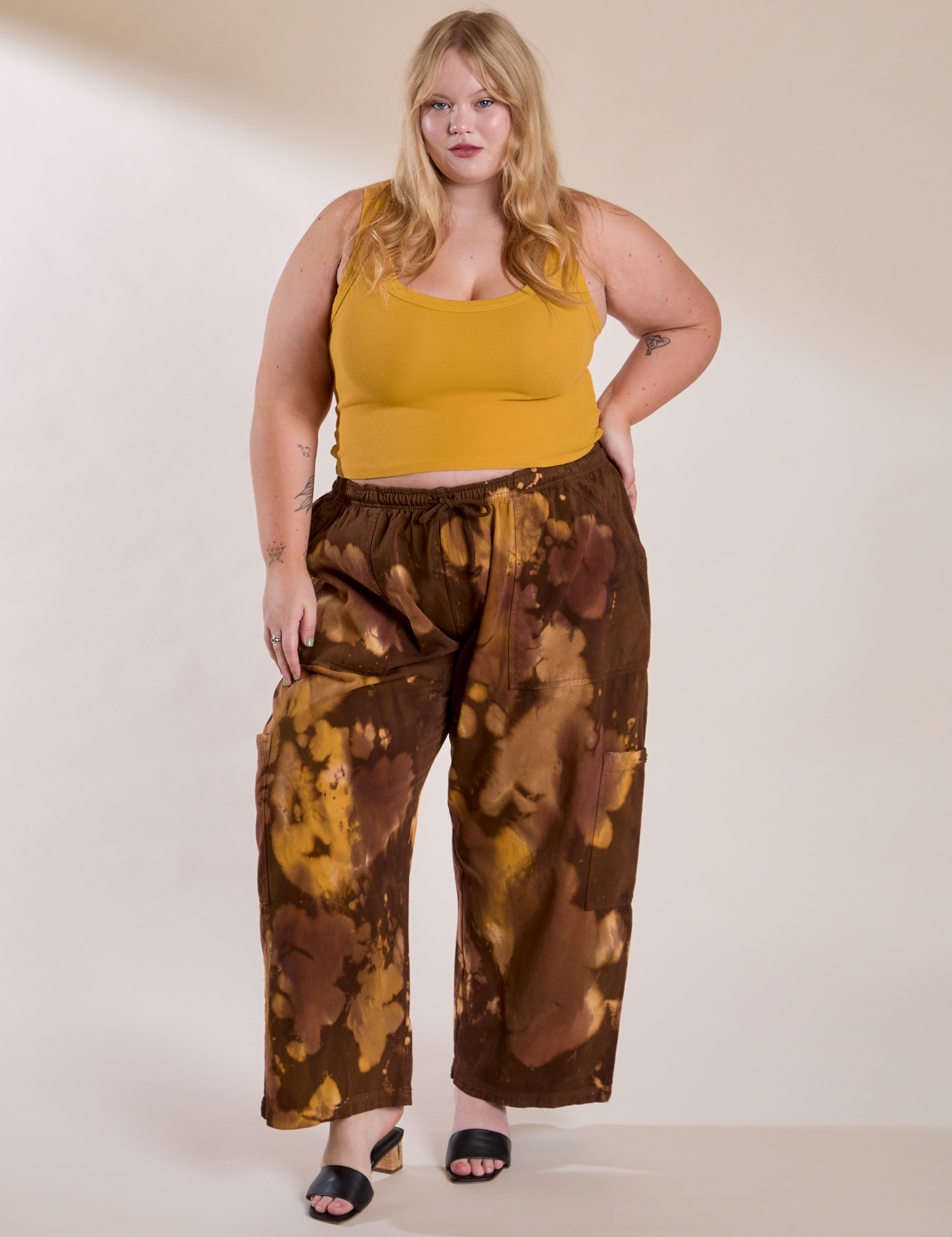 Juliet is 5'7" and wearing 1XL Magic Waters Drop Pocket Pants in Honey Brown paired with mustard yellow Cropped Tank