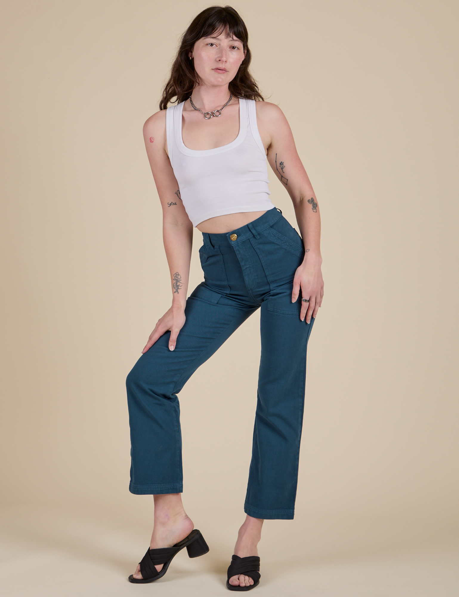 Alex is wearing Work Pants in Lagoon and vintage tee white Cropped Tank