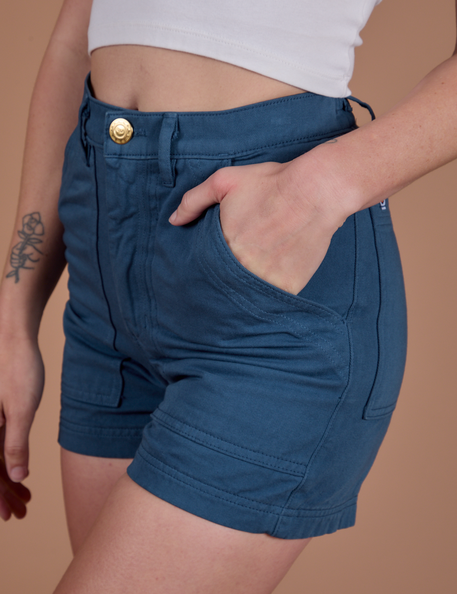 Close up of Alex's hand in the front pocket of Classic Work Shorts in French Blue