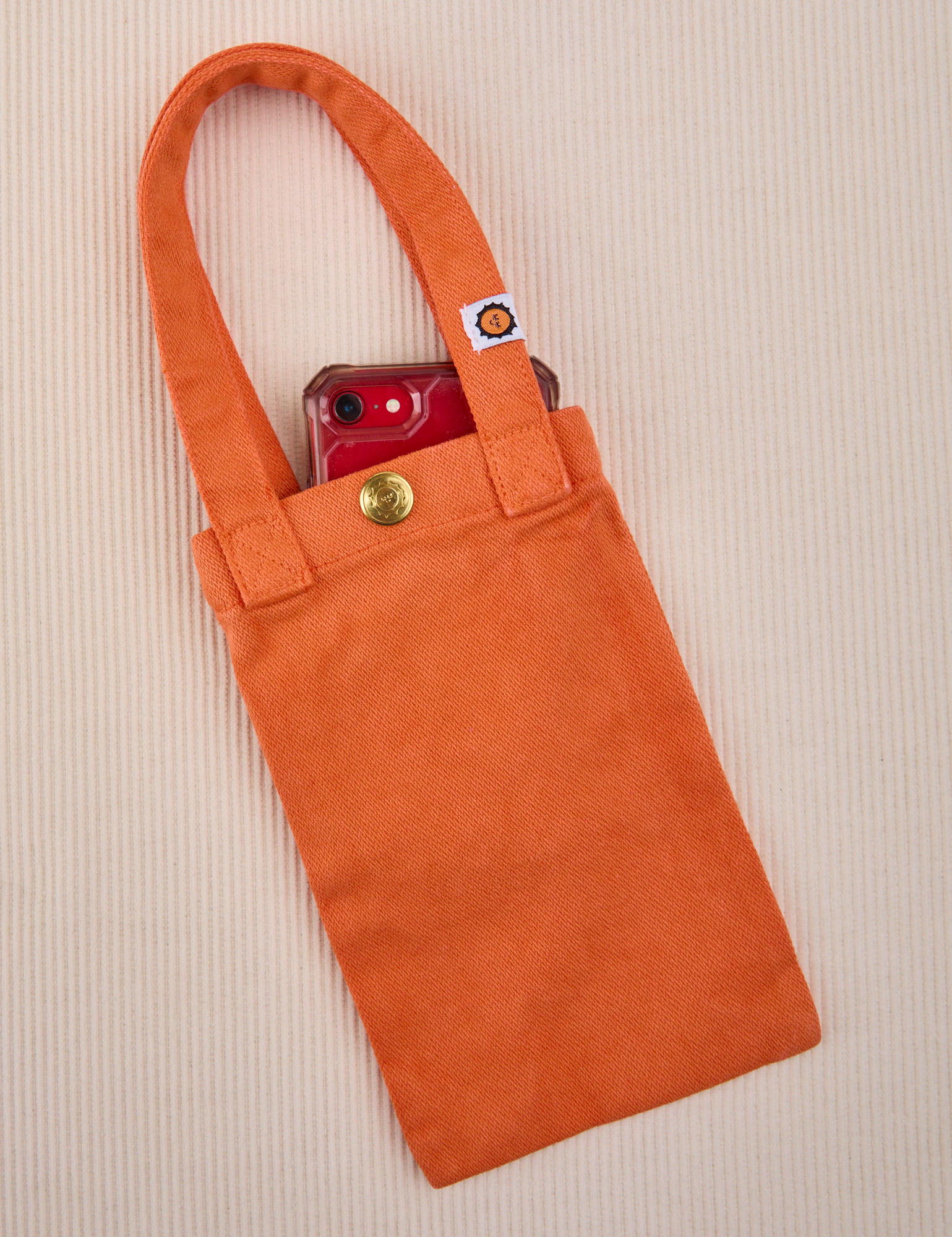 Phone tucked into construction orange Cell Phone Tote