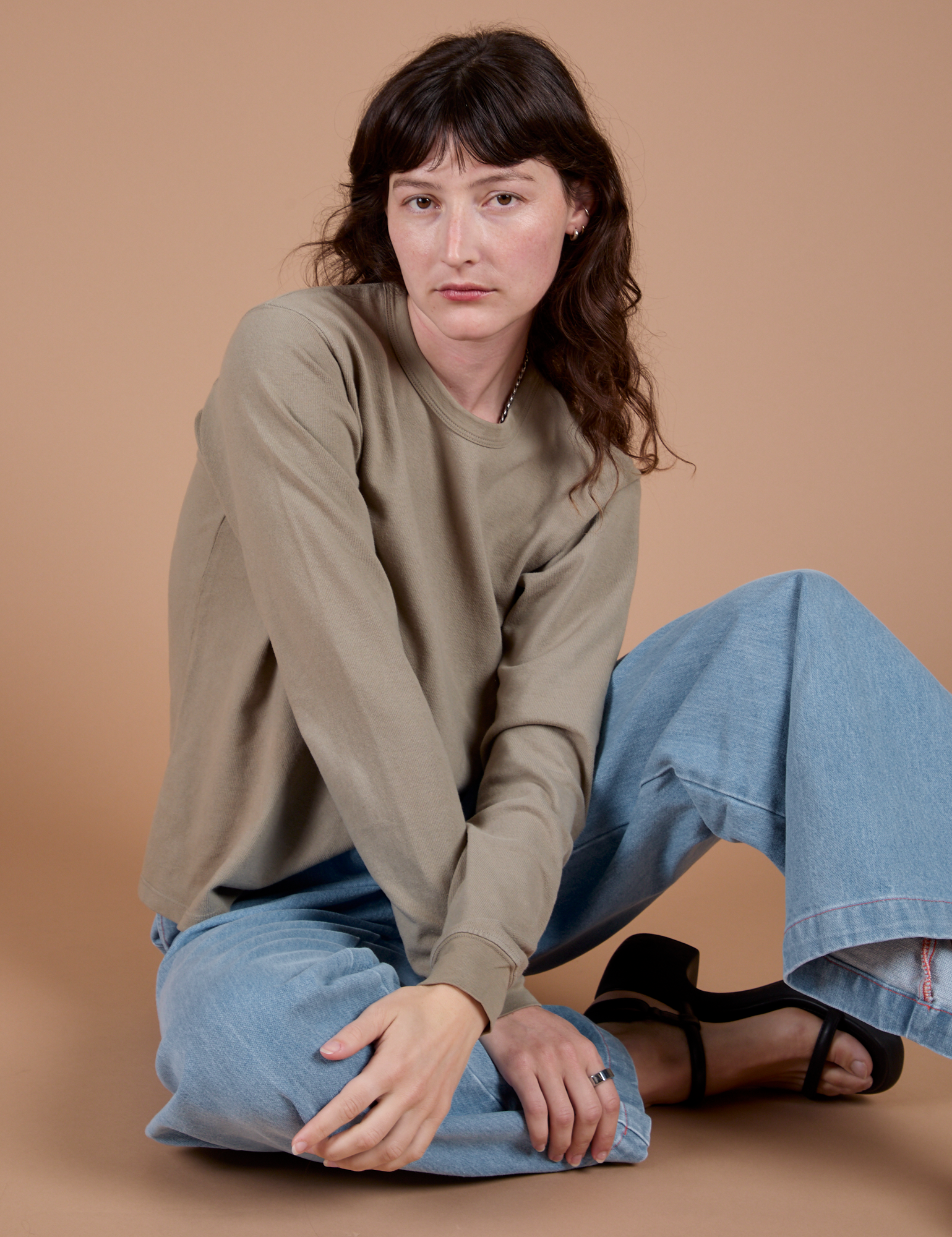 Alex is wearing Long Sleeve Burly Tee in Khaki Grey