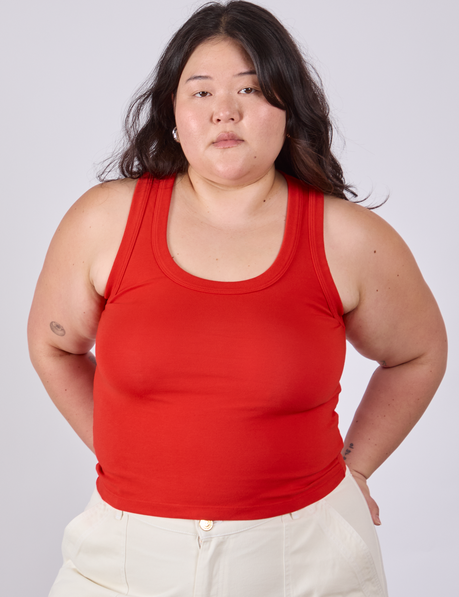 Ashley is 5'7" and wearing L Tank Top in Mustang Red