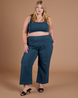 Juliet is 5’7” and wearing 1XL Action Pants in Lagoon paired with lagoon Mini Tank