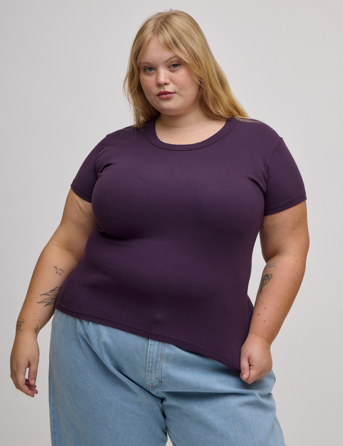 Juliet is 5'7" and wearing L Baby Tee in Nebula Purple