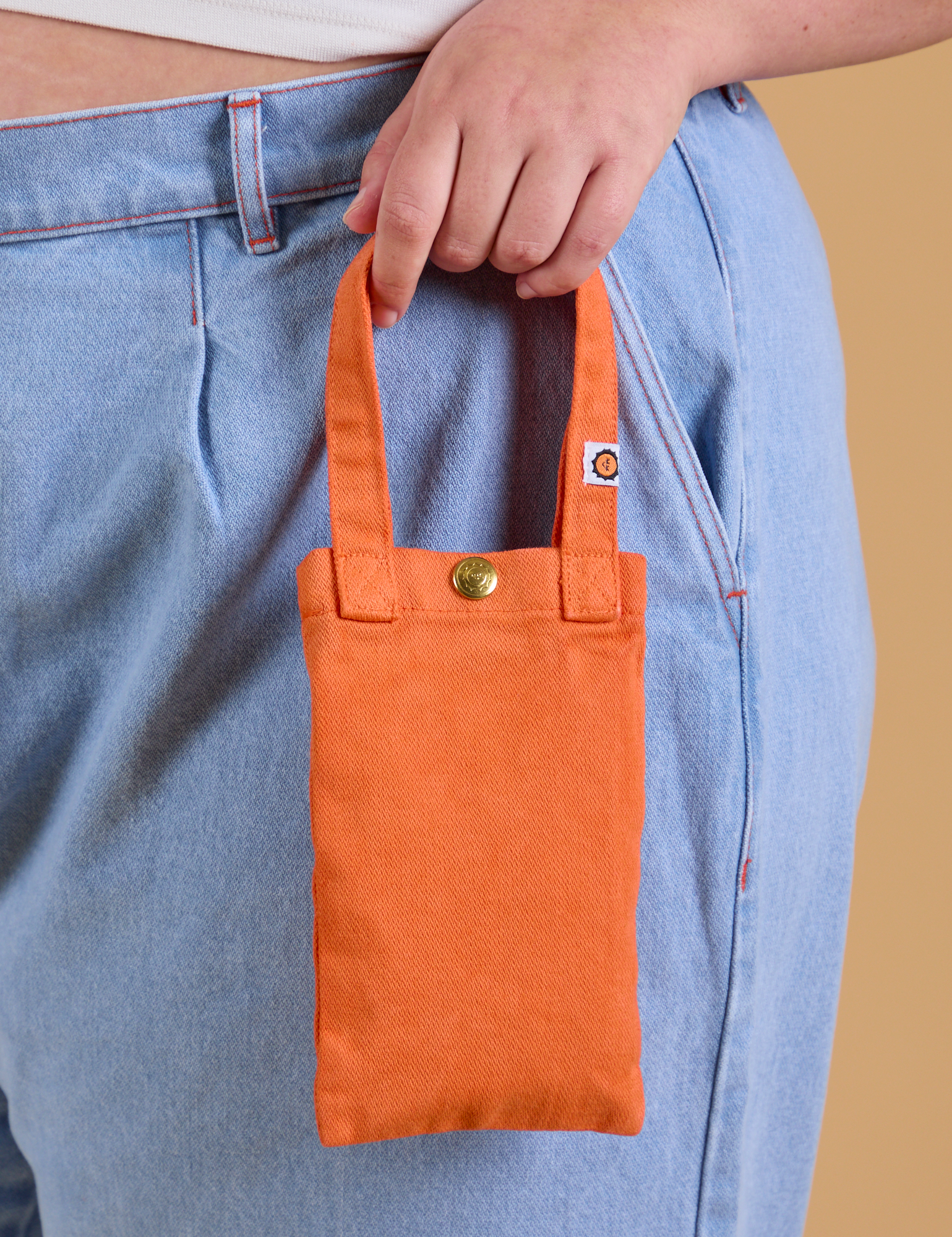 Cell Phone Tote in Construction Orange held by model
