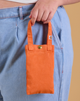 Cell Phone Tote in Construction Orange held by model