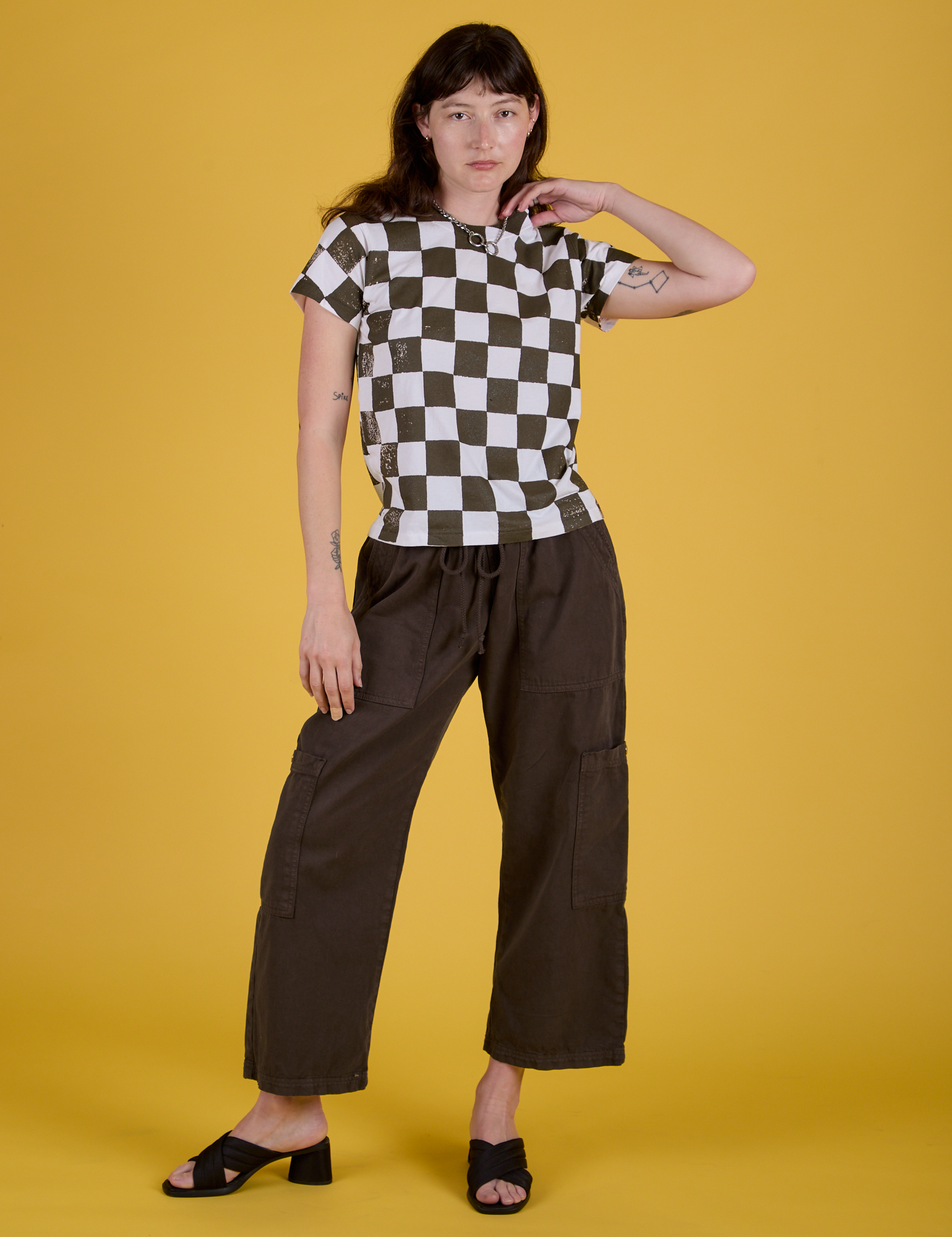 Alex is wearing Checker Organic Tee in Espresso Brown and Drop Pocket Cargo Pants in Espresso Brown