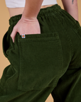 Close up of Alex's hand in the back pocket of Corduroy Drop Pocket Cargo Pants in Evergreen