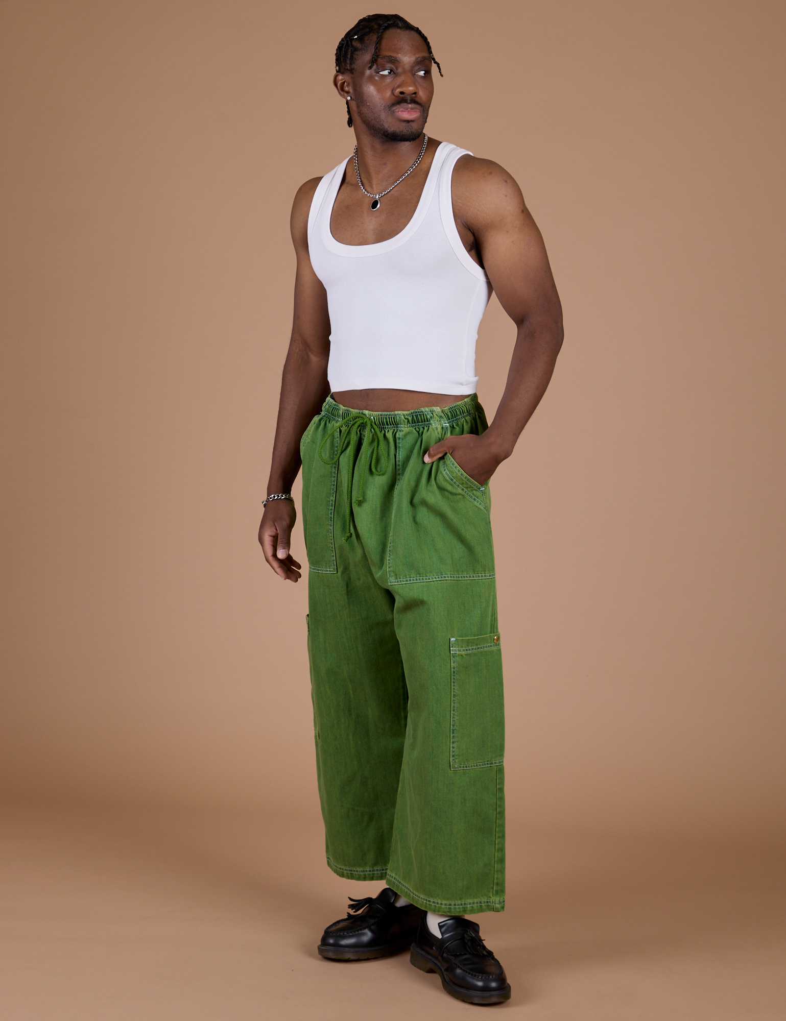 Angled front view of Denim Drop Pocket Pants in Green Overdye and Cropped Tank in Vintage Tee White