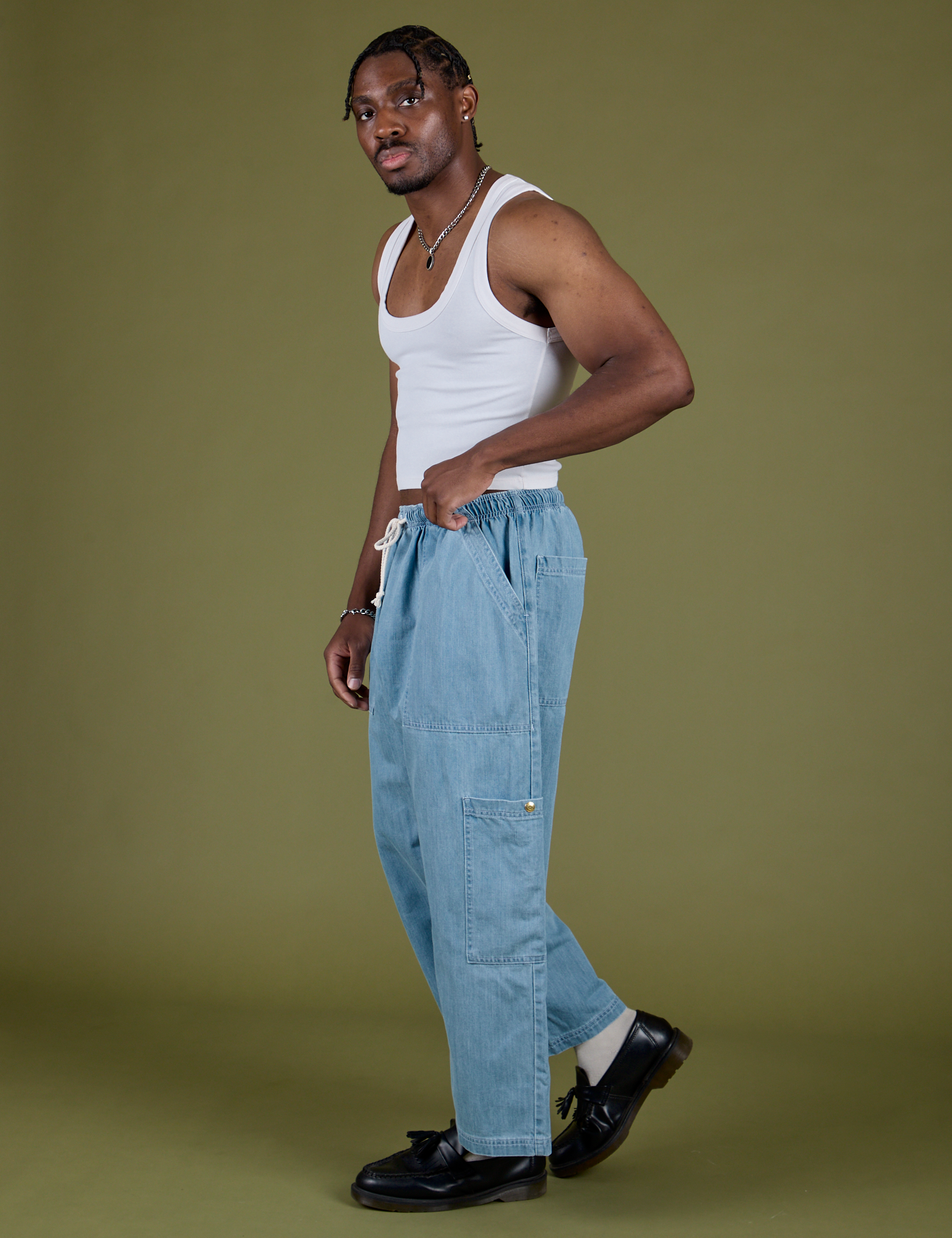 Side view of Denim Drop Pocket Pants in Light Wash and Cropped Tank in Vintage Tee White on Isaac