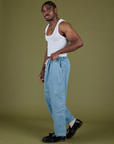 Side view of Denim Drop Pocket Pants in Light Wash and Cropped Tank in Vintage Tee White on Isaac