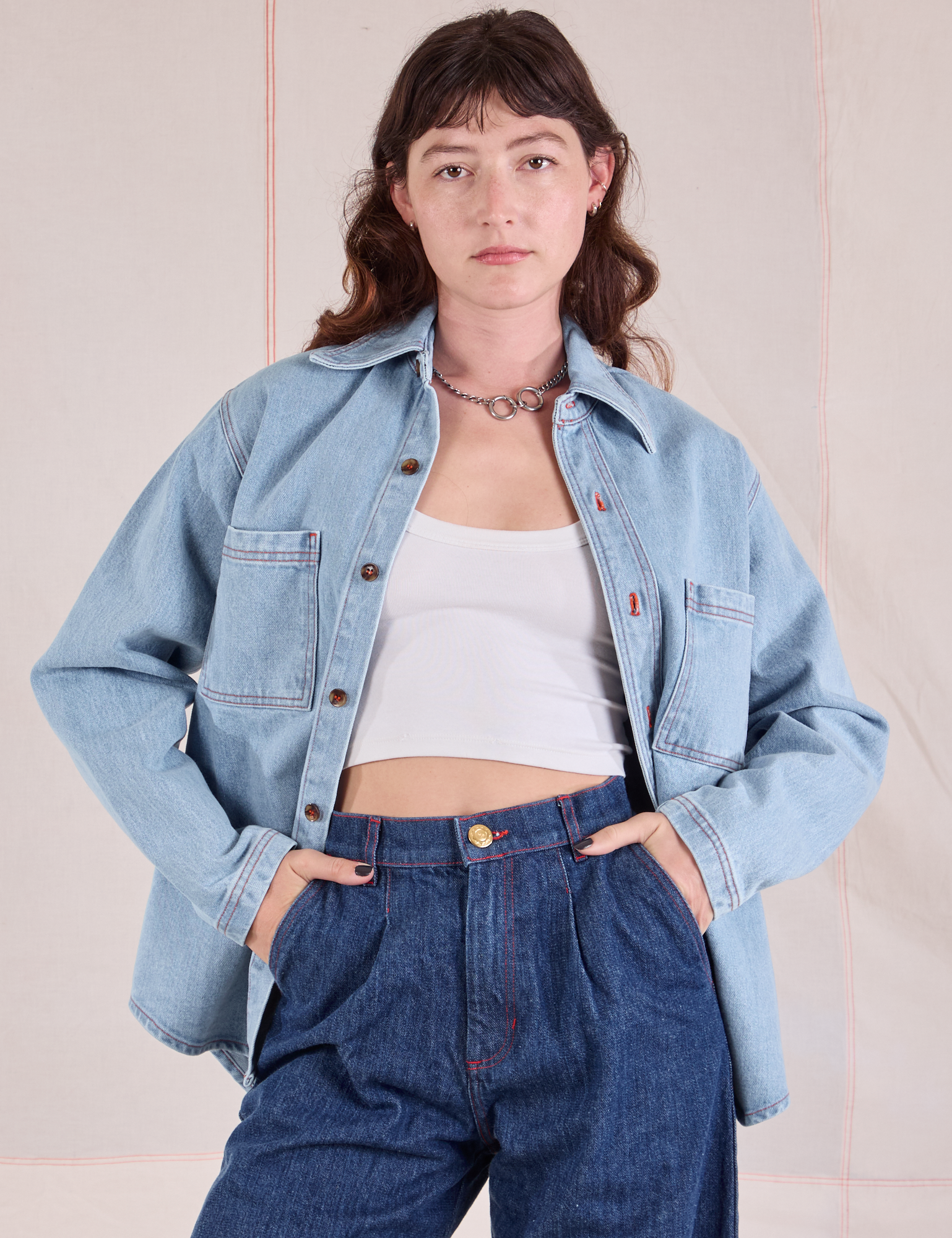 Alex is 5'8" and wearing P Denim Overshirt in Light Wash paired with dark wash Denim Trousers