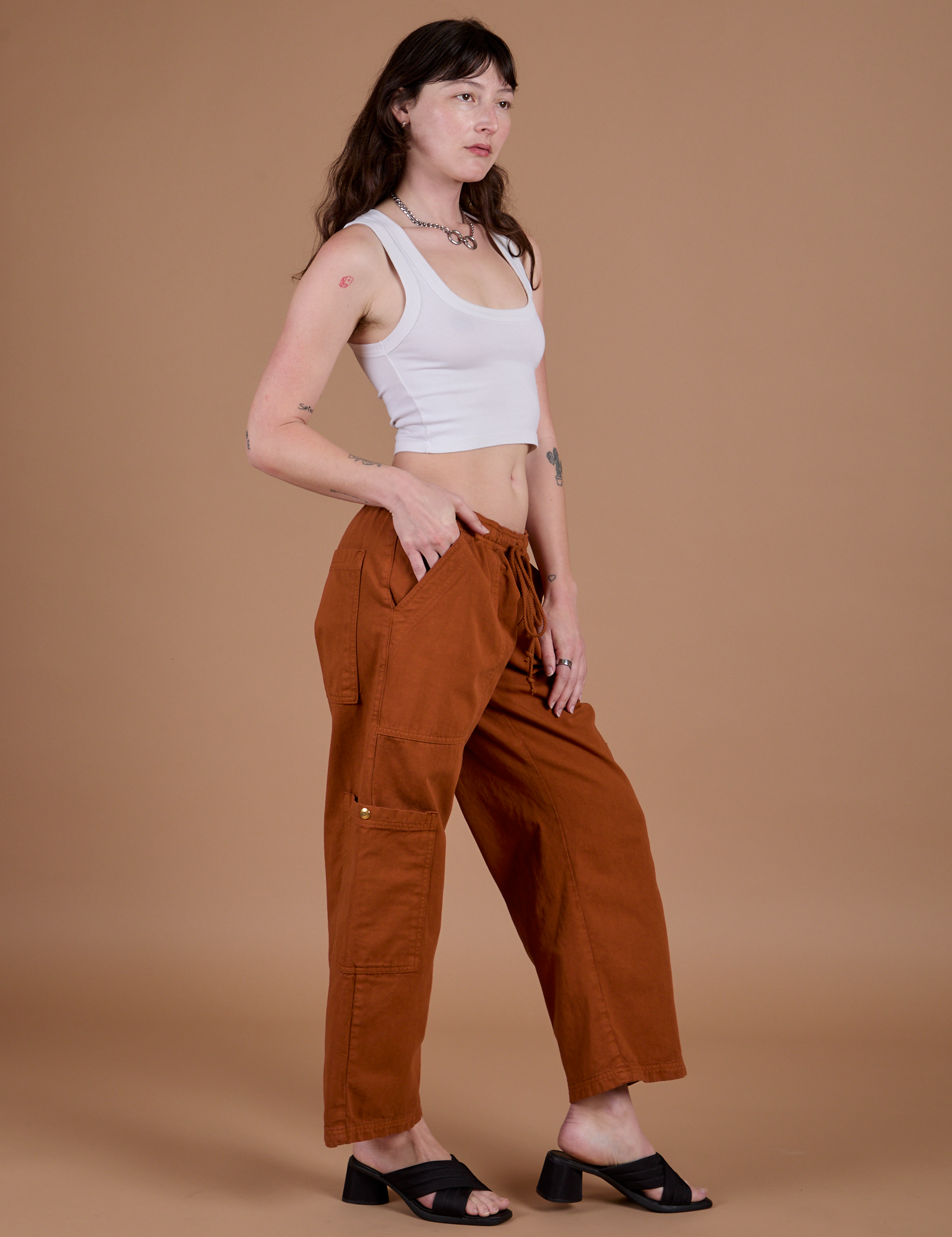 Side view of Drop Pocket Cargo Pants in Burnt Terracotta and vintage tee white Cropped Tank