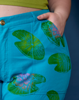 Close up of Ashley's hand in the front pocket of Paintstamped Work Pants in Lilypad