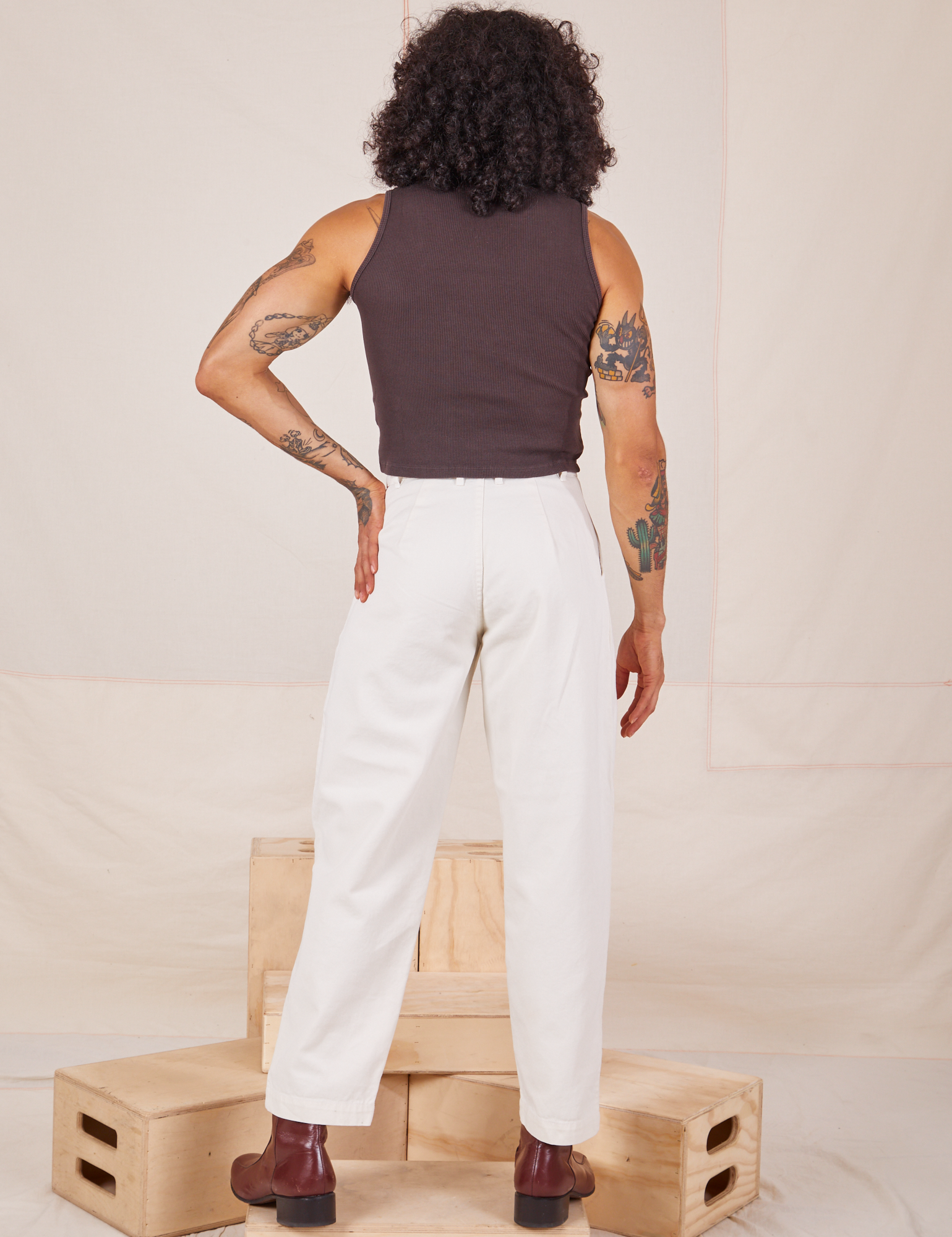 Back view of Heavyweight Trousers in Vintage Tee Off-White and espresso brown Sleeveless Turtleneck worn by Jesse.