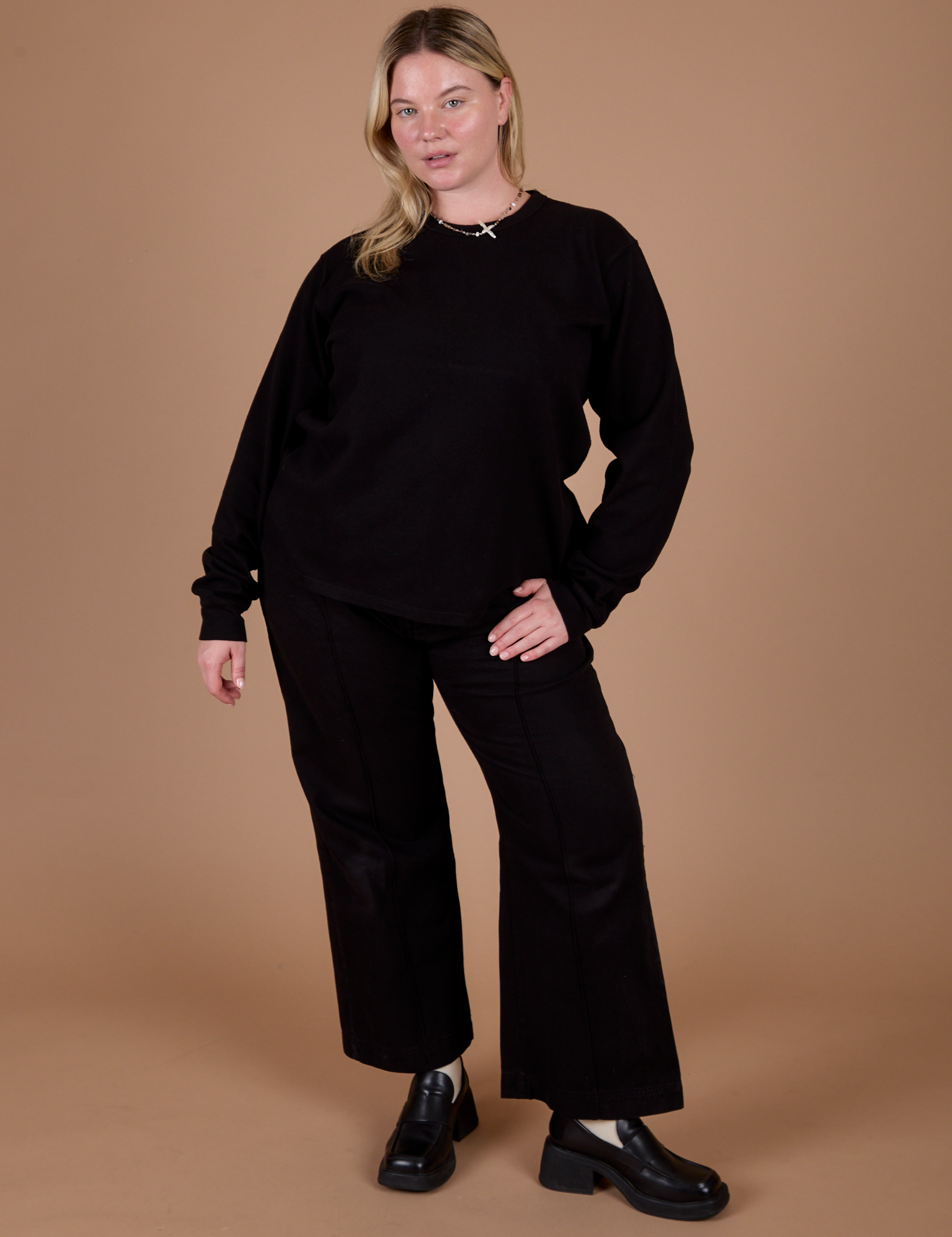 Lish is wearing Long Sleeve Burly Tee in Basic Black paired with black Western Pants