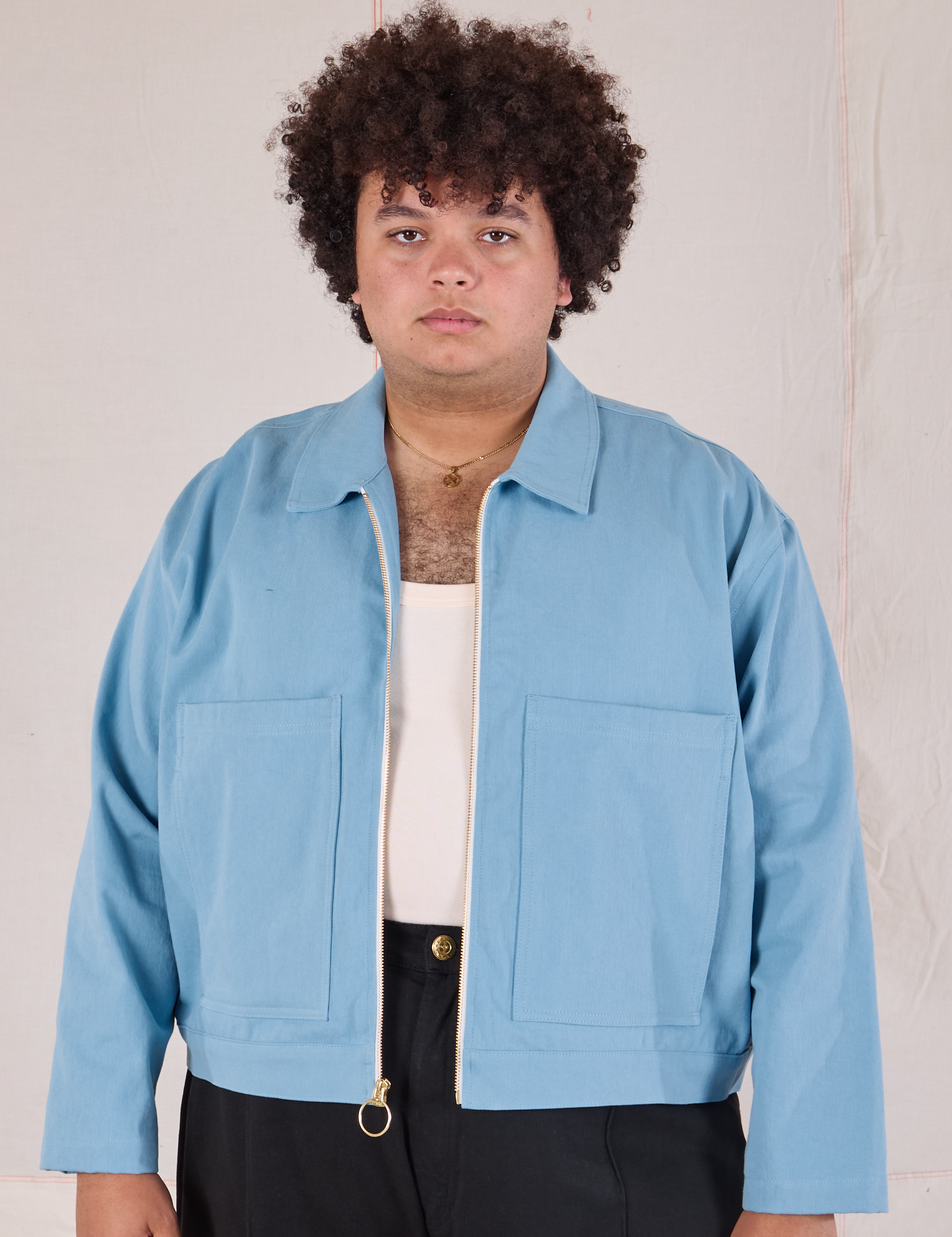 Miguel is 6’0” and wearing 1XL Mechanic Jacket in Baby Blue