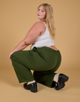 Angled back view of Baggy Mid-Rise Trousers in Evergreen on Juliet