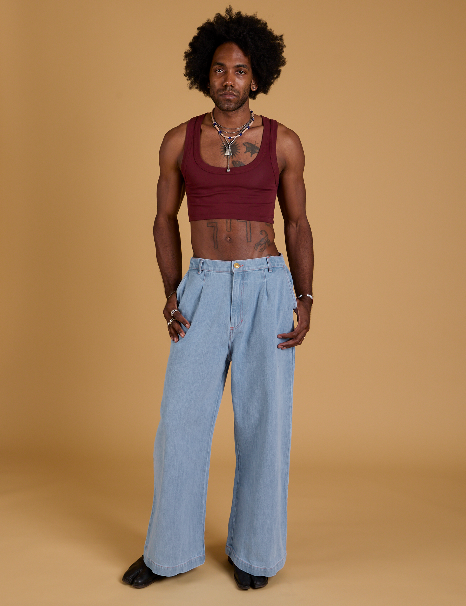 Jerrod is wearing Mini Tank in Red Wine and light wash Indigo Wide Leg Trousers