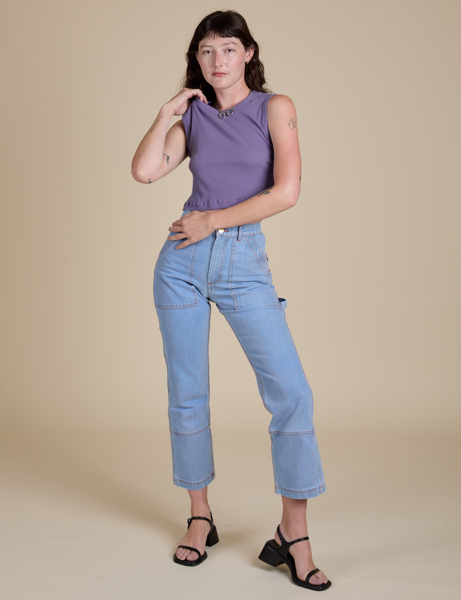 Alex is wearing Muscle Tee in Faded Grape and light wash Carpenter Jeans
