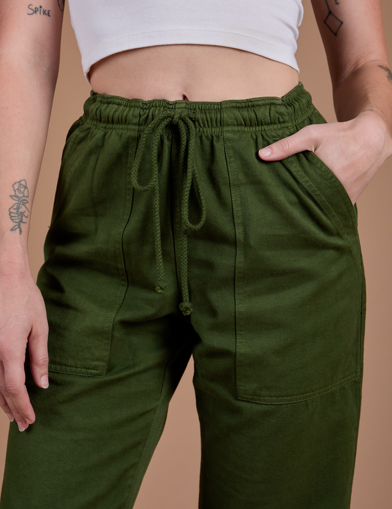 Organic Action Pants in Evergreen front close up on Alex