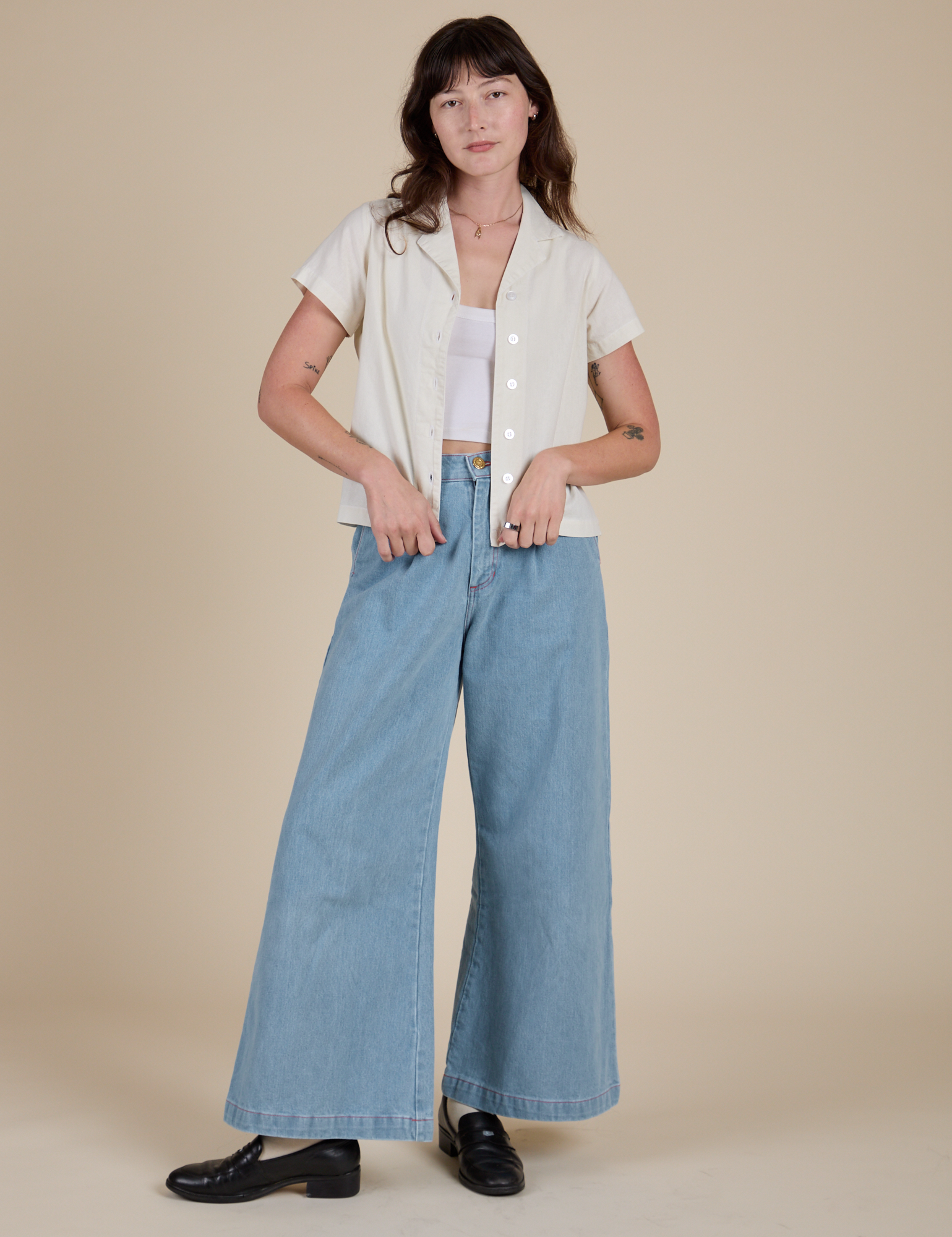 Alex is wearing Pantry Button-Up in Vintage Tee White and light wash Indigo Wide Leg Trousers