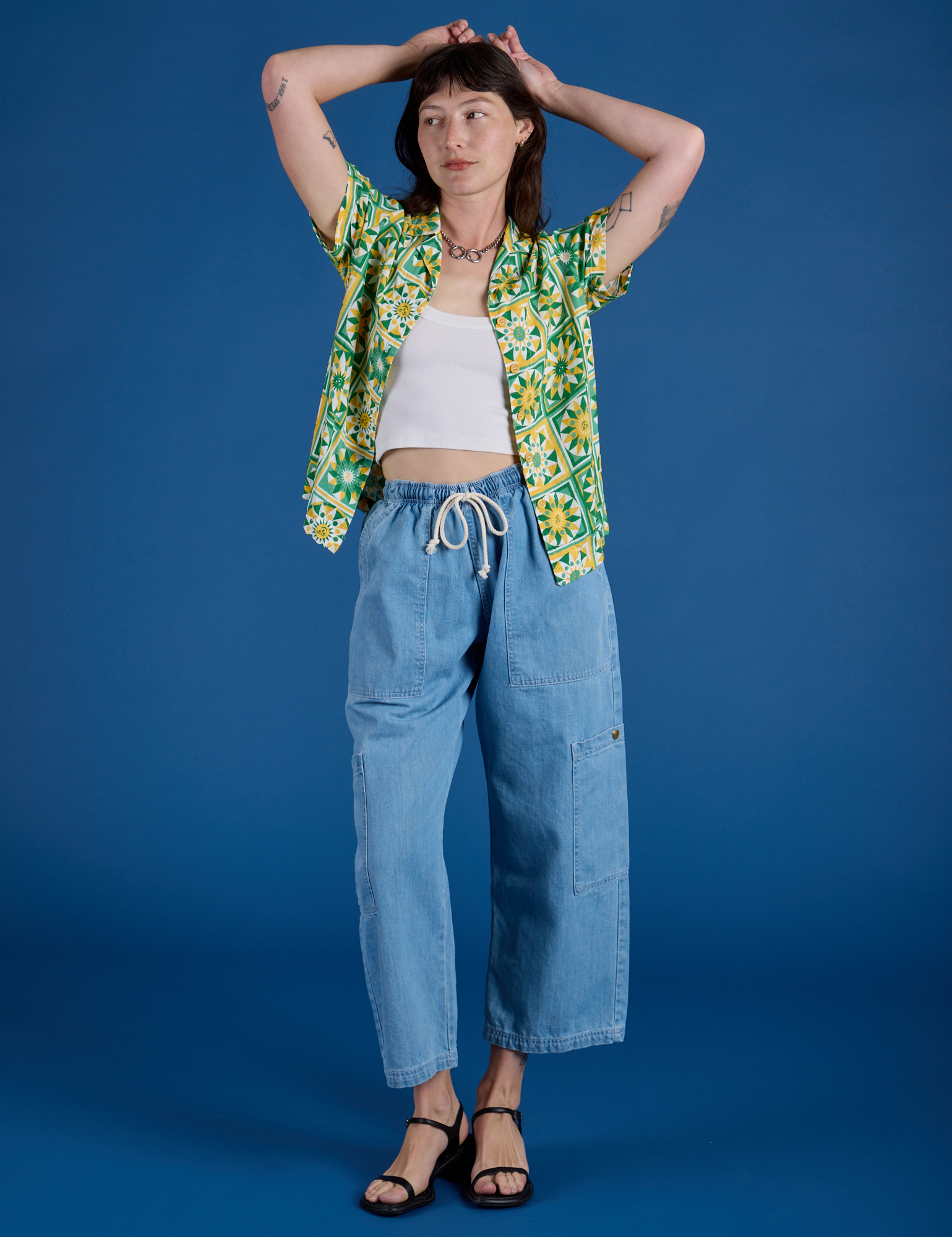 Alex is wearing Spring Quilt Print Pantry Button-Up paired with light wash Denim Drop Pocket Pants
