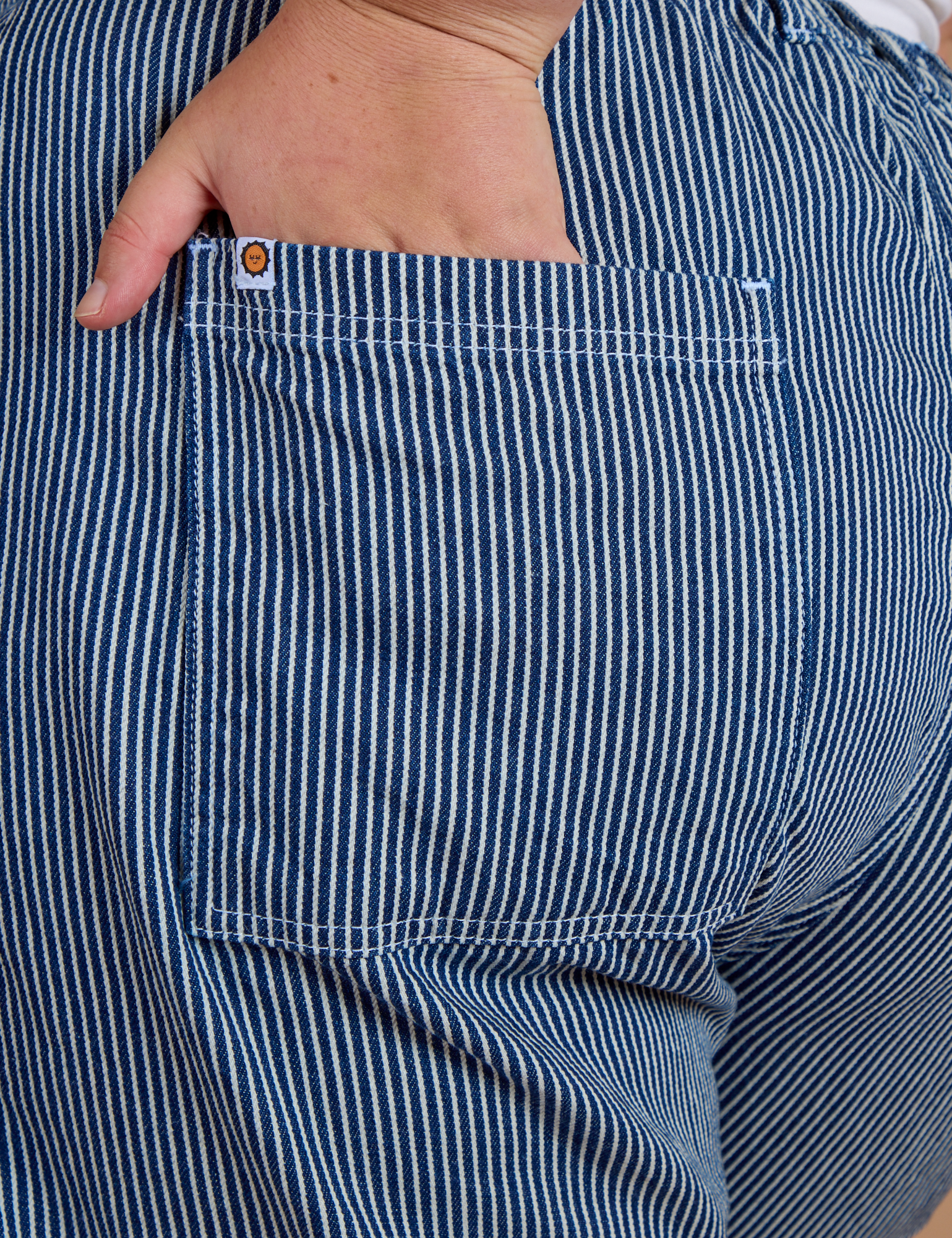 Close up of Juliet's hand in the back pocket of Railroad Denim Work Pants in Natural