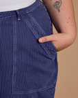 Close up of Juliet's hand in the front pocket of Railroad Denim Work Pants in Faded Grape Overdye 