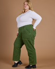 Side view of Railroad Denim Work Pants in Gross Green Overdye and vintage tee white long sleeve baby tee on Juliet