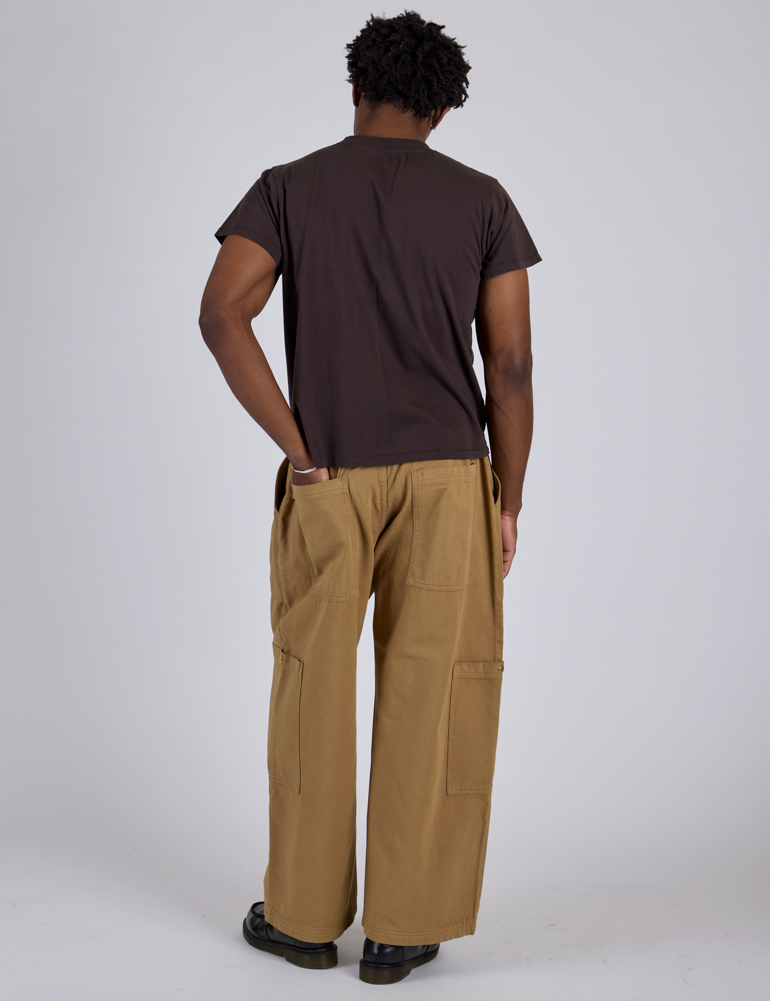 Back view of Drop Pocket Cargo Pants in Desert Brown and espresso brown Organic Vintage Tee on Isaac