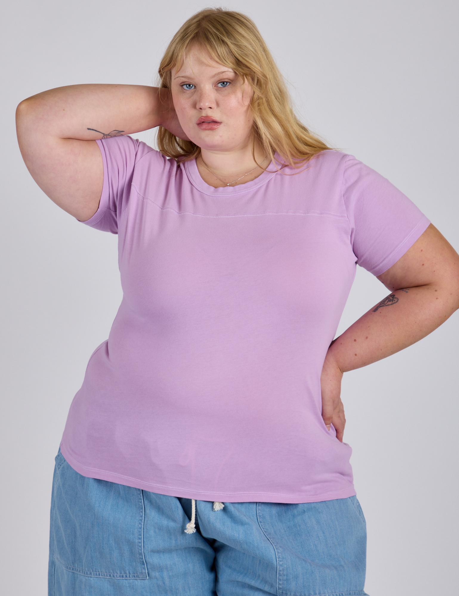 Juliet is 5’7” and wearing L Jr. Varsity Tee in Lilac Purple