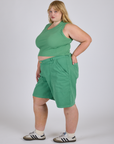 Side view of Longline Work Shorts in Seafoam Green paired with matching muscle tee on Juliet