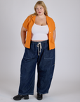 Juliet is wearing Pantry Button-Up in Creamsicle Orange and dark wash Denim Drop Pocket Pants