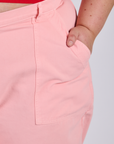 Close up of Juliet's hand in the front pocket of Work Pants in Baby Pink