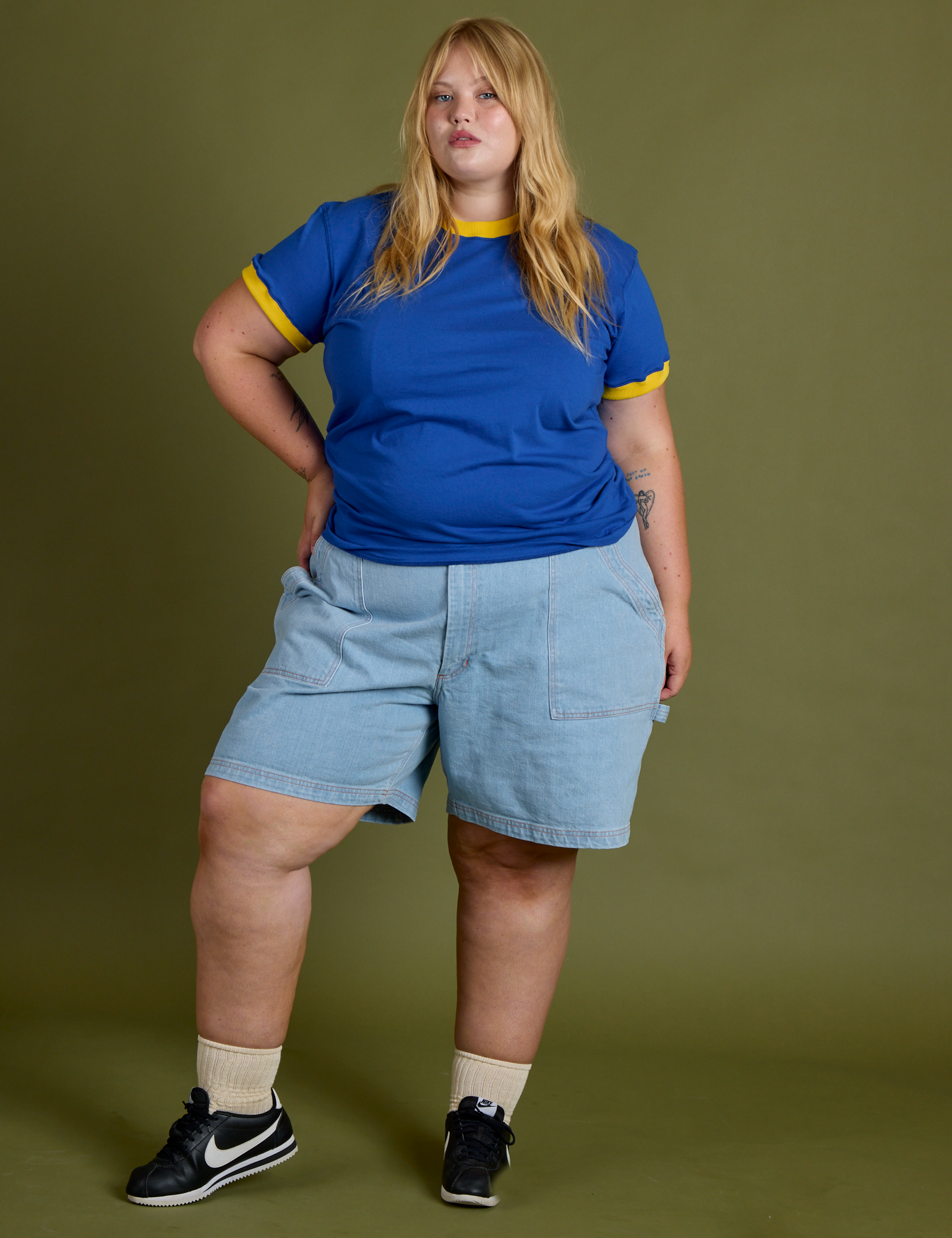 Juliet is wearing Vintage Ringer Tee in Royal Blue and Carpenter Shorts in Light Wash