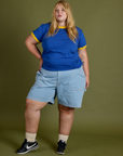 Juliet is wearing Vintage Ringer Tee in Royal Blue and Carpenter Shorts in Light Wash