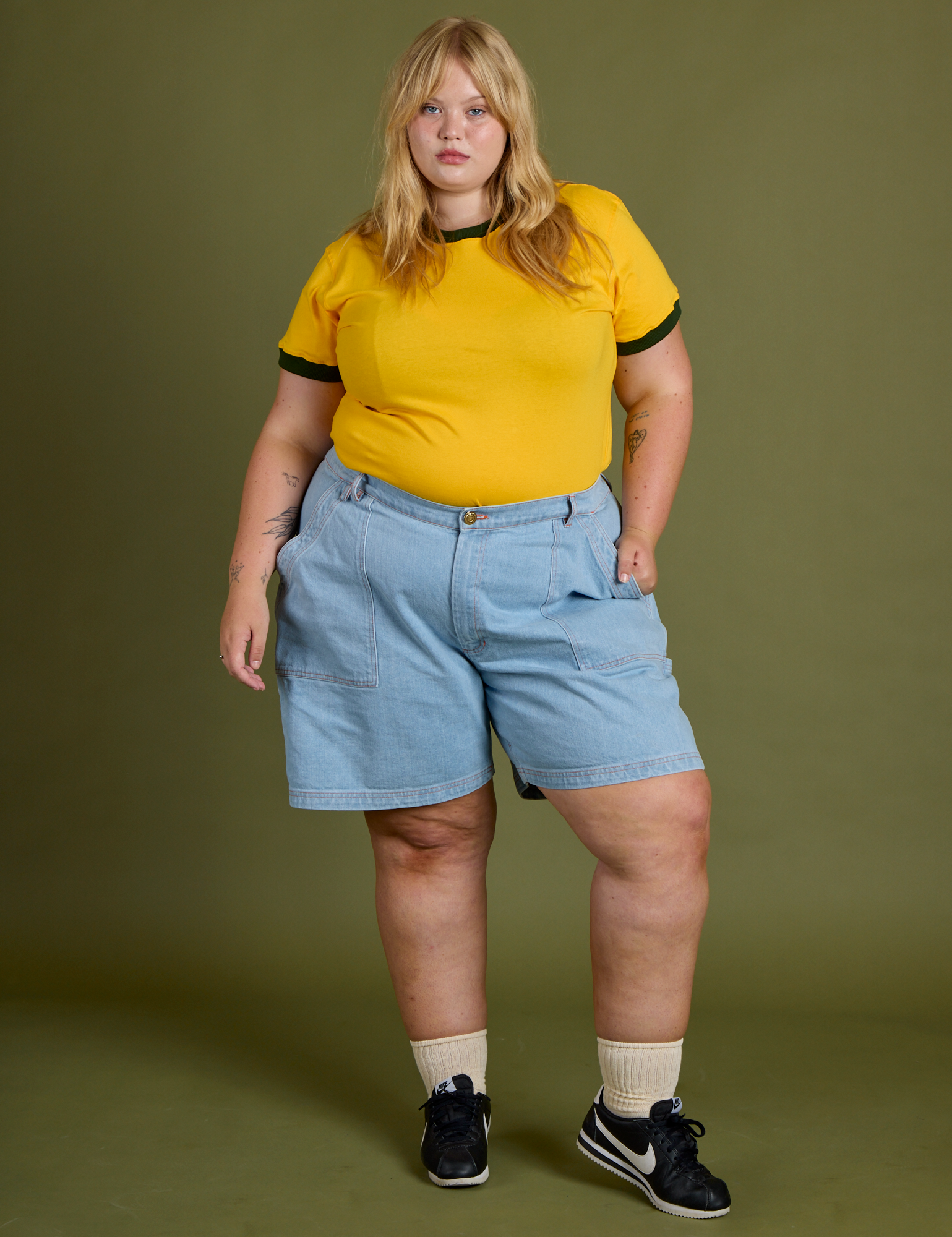 Juliet is wearing Vintage Ringer Tee in Sunshine Yellow and light wash Carpenter Shorts