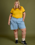 Juliet is wearing Vintage Ringer Tee in Sunshine Yellow and light wash Carpenter Shorts