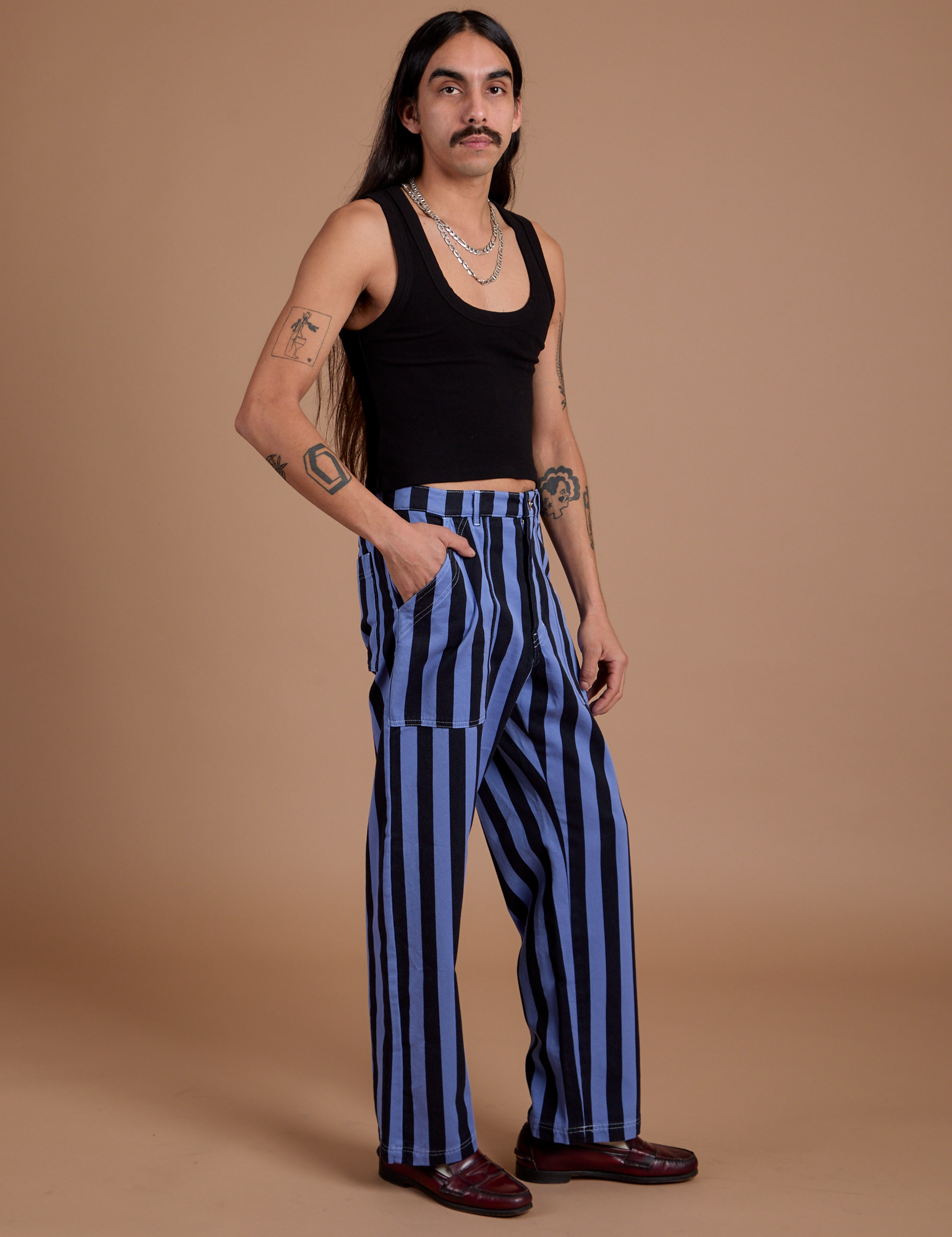 Angled front view of Black Stripe Work Pants in Cornflower Blue and black Cropped Tank on Anthony